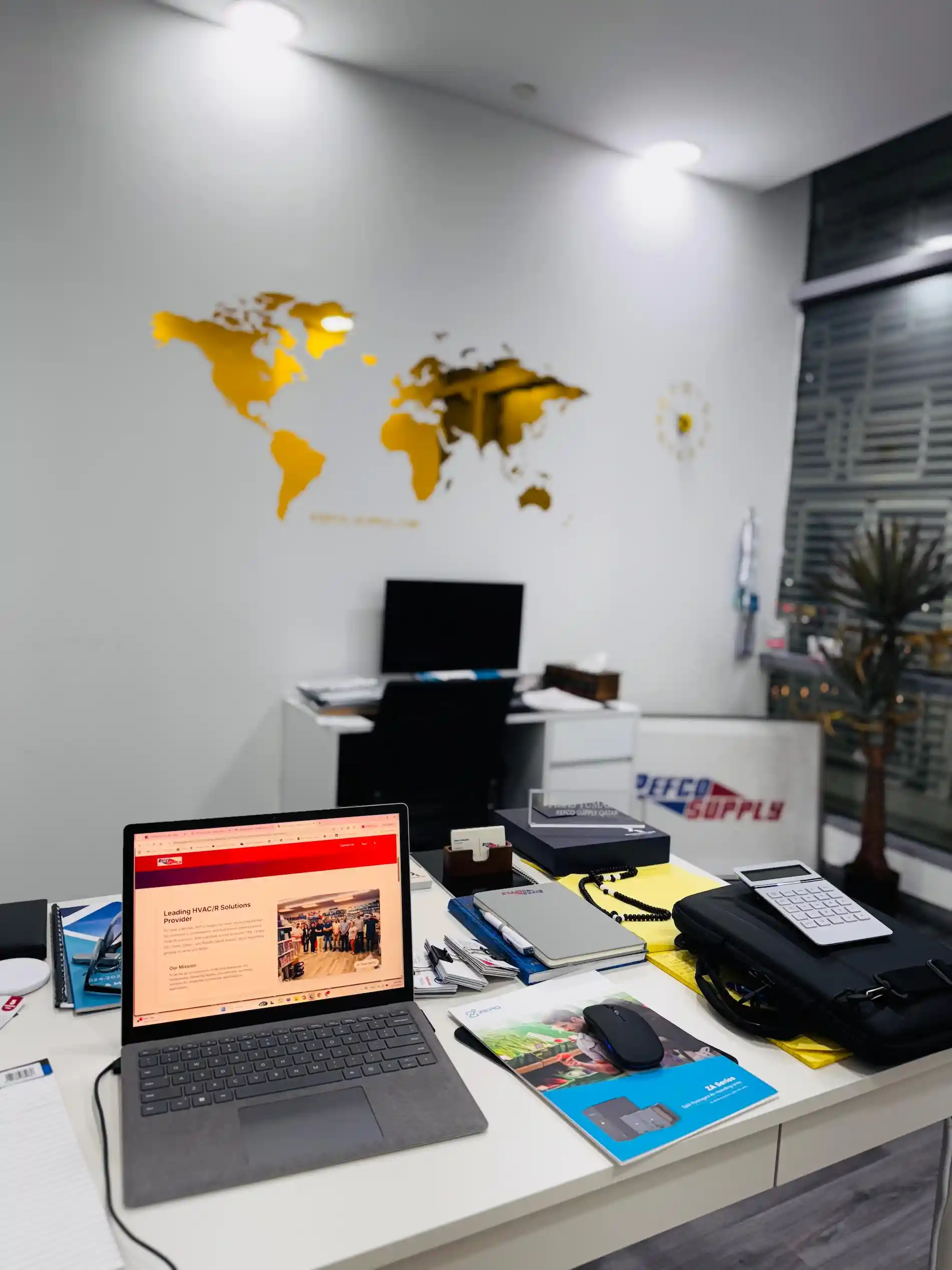 Professional Refco team at work - modern office with world map and laptops